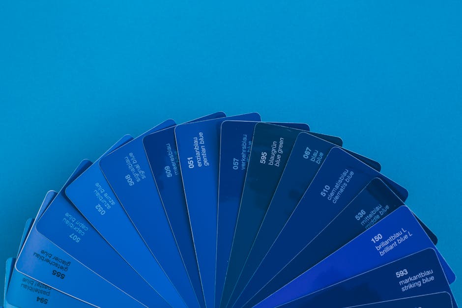 A fan arrangement of vibrant blue color swatches on a bold blue background.